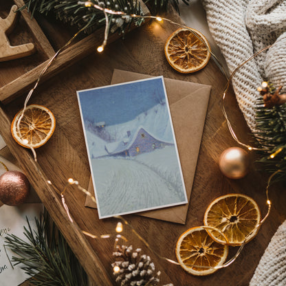 Winter scene greeting card with envelope on a wooden surface with decorative elements