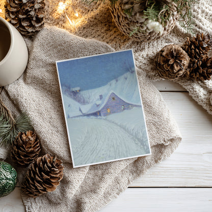 Winter-themed card with a snowy landscape and house, surrounded by pine cones and a mug on a textured surface.