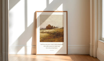Framed artwork on a wall in a bright room with sunlight streaming through windows.